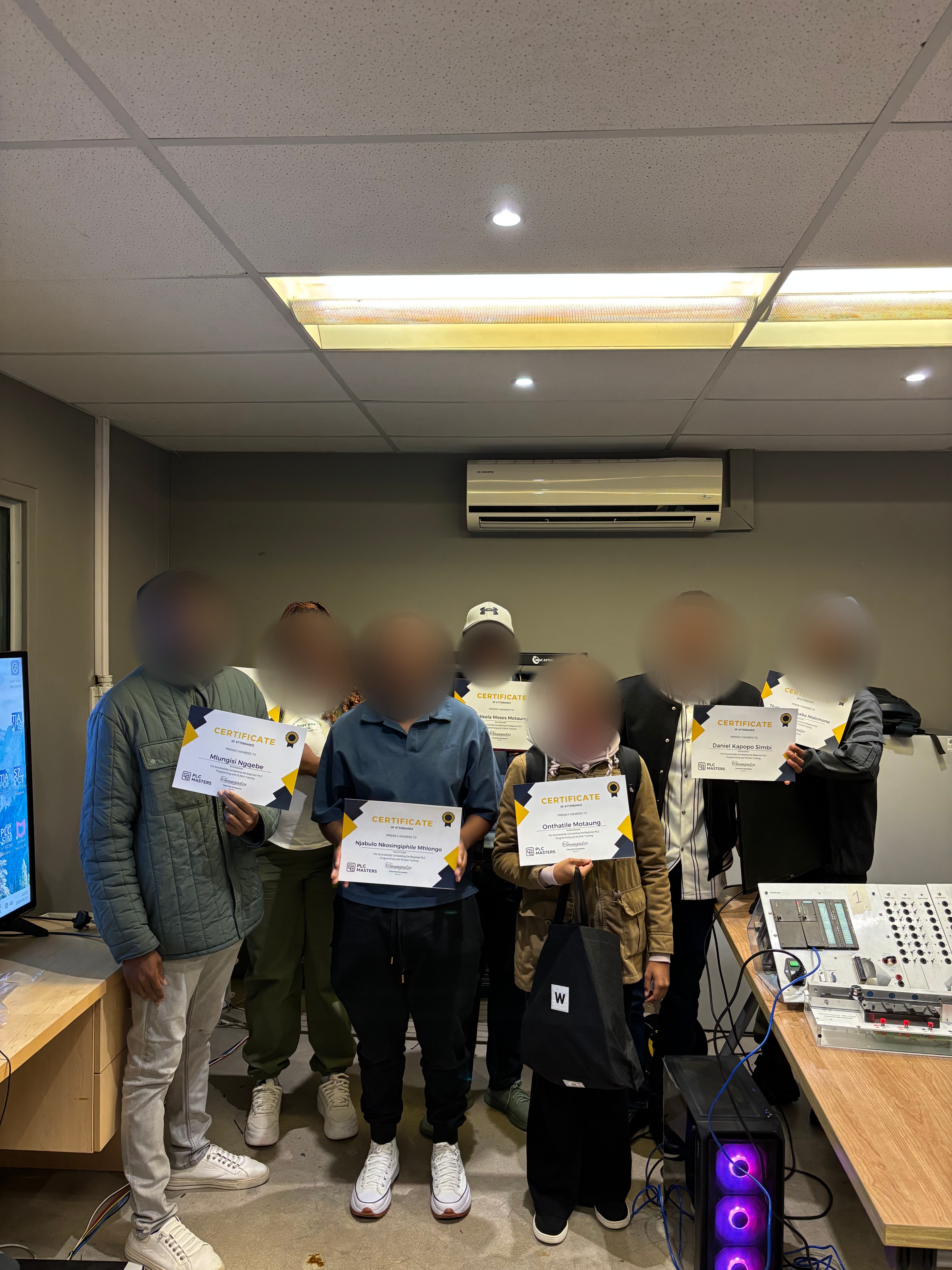 PLC Masters graduates with their certificates of completion