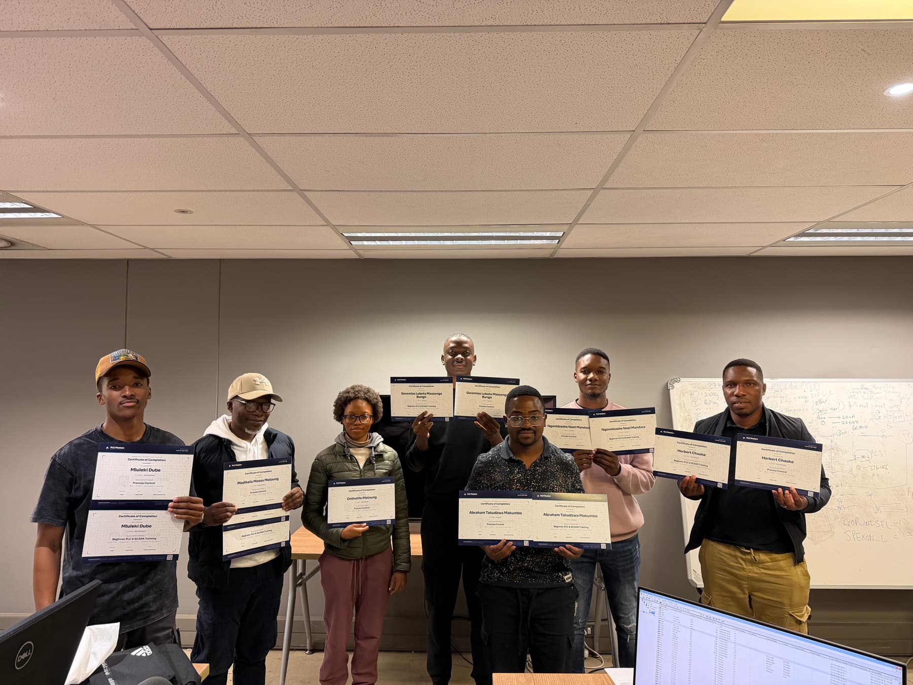 A Process Control class holding their certificates of completion